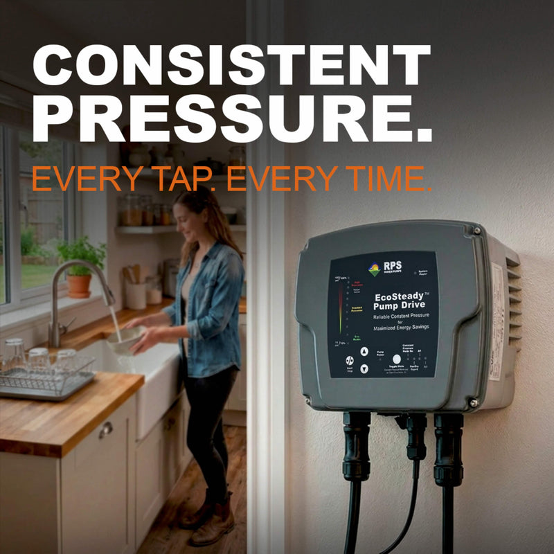 Woman washing dishes in a kitchen with a controller for a constant pressure water system on the wall.